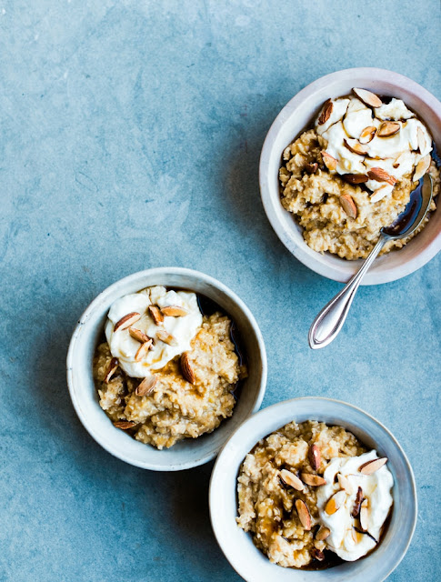 Three bowls of Overnight Sweet Potato Oats topped with yoghurt, maple syrup and almonds.