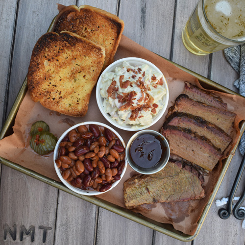 Smoked brisket platter with mixed chili beans, roasted jalapeno potato salad, and Texas toast.