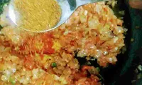Adding spices into masala for egg bhurji