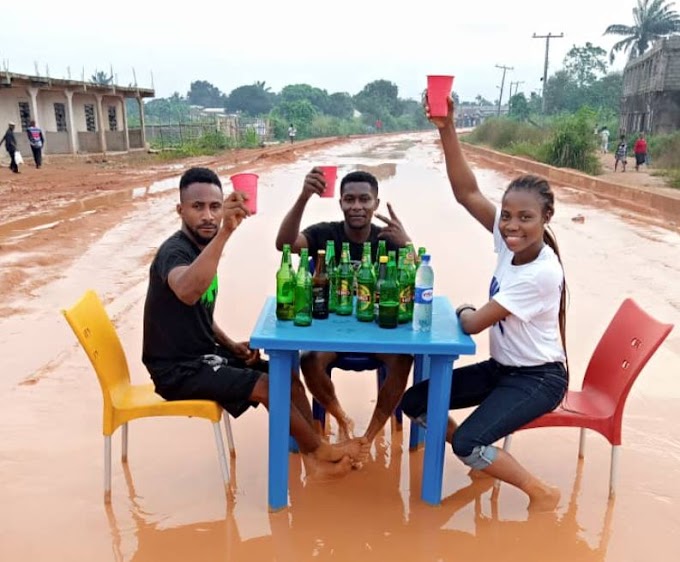 Friends Drink Beer On A Bad Road In Owerri To Draw Attention To The State Of The Road