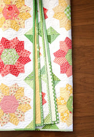 Dahlia quilt - an english paper pieced quilt by Andy of A Bright Corner with a fun scrappy binding