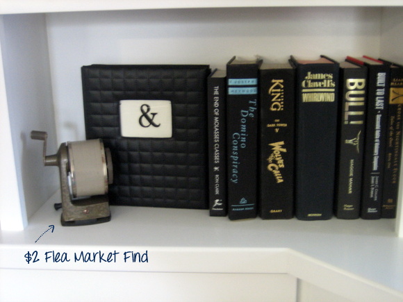 These black books look great next to one another on this bookshelf. 