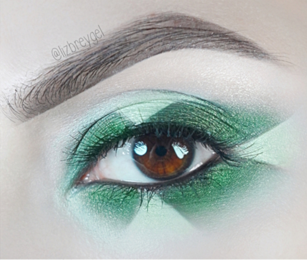 close-up of an eye with a dramatic green makeup look inspired by emerald stone