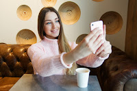girl taking selfie with smartphone