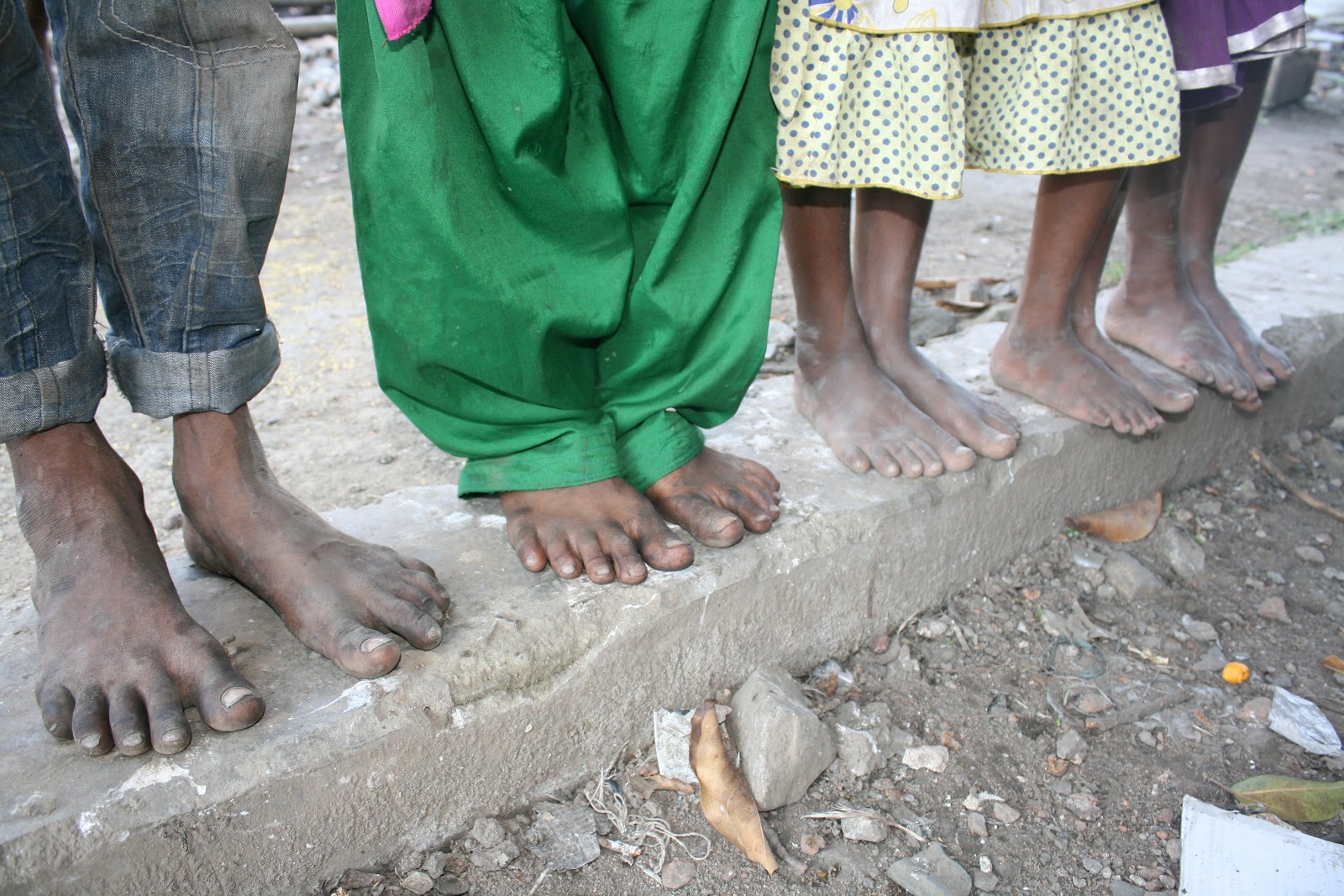 Smiles from India Bare feet, a trash bag, some pepsi and love.