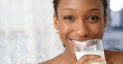 Black woman drinking almond milk