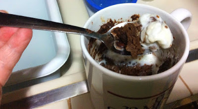 spoon in mug cake with whipped cream