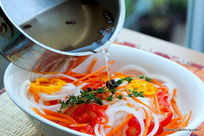 Pouring the marinating vinegar liquid on the veggies