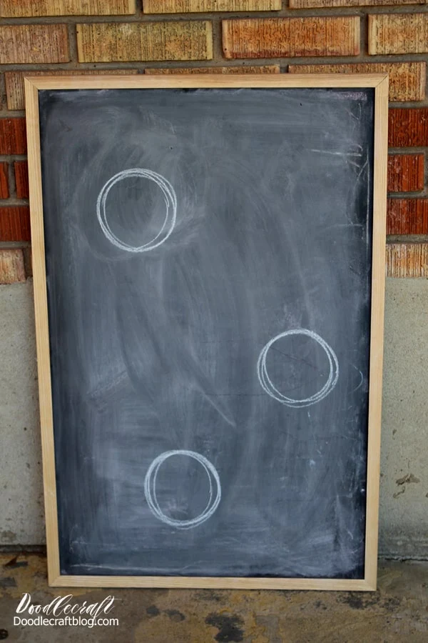 Circles drawn in chalk on an old chalkboard ready to upcycle into a bean bag toss game