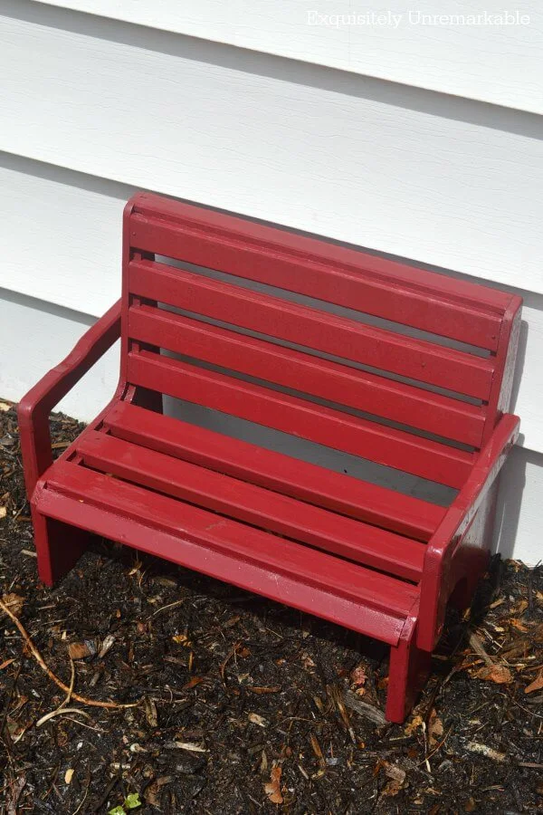 Little Red Wooden Bench in dirt patch