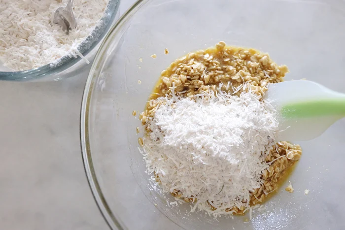 adding flour and parmesan to oat mix