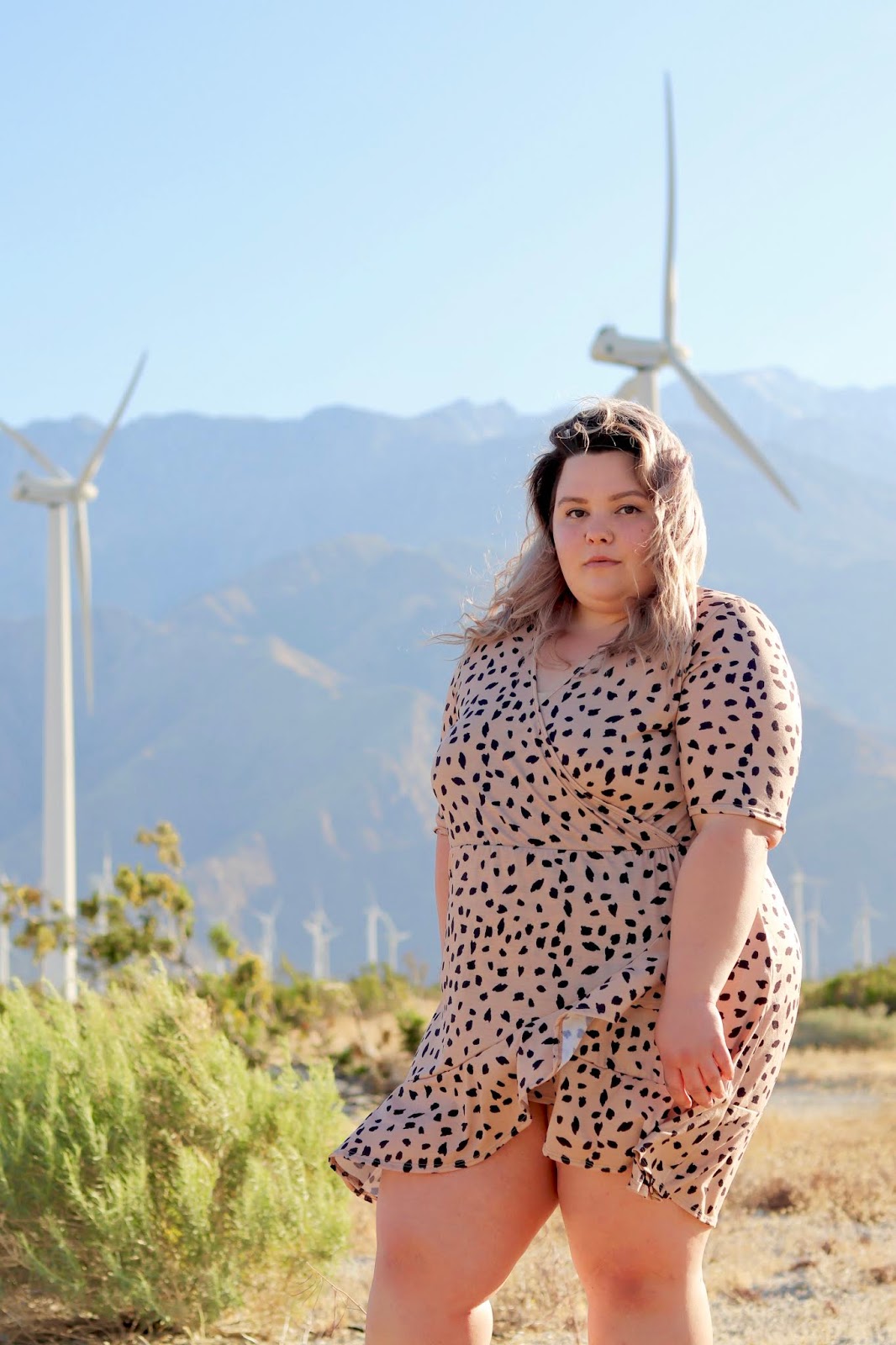 Chicago Plus Size Petite Fashion Blogger, YouTuber, and model Natalie Craig, of Natalie in the City, reviews Pink Clove's mini wrap dress and attends Her Conference in Los Angeles. palm springs windmills, best places to take photos in palm springs