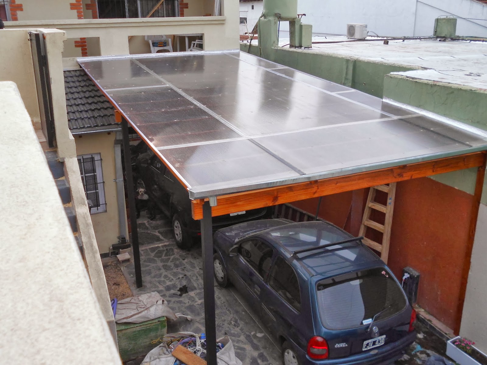 Entrepisos de madera, escaleras.: Garage con policarbonato