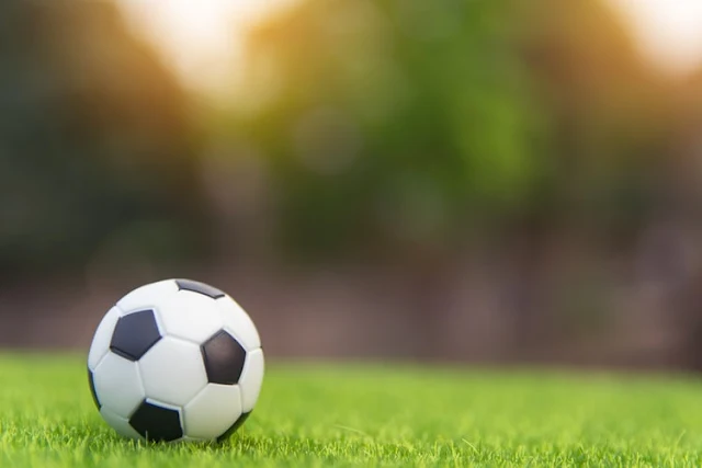 Soccer ball on grass green field with copy space unsplash