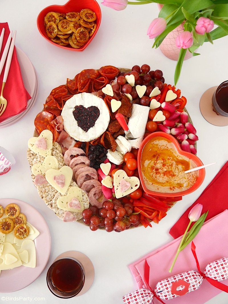 Valentine's Day Cheese and Charcuterie Board - easy, pretty, delicious grazing board filled with pink & red foods to celebrate love day at home! by BirdsParty.com @birdsparty #cheeseboard #charcuterieboard #valentinesday #recipes