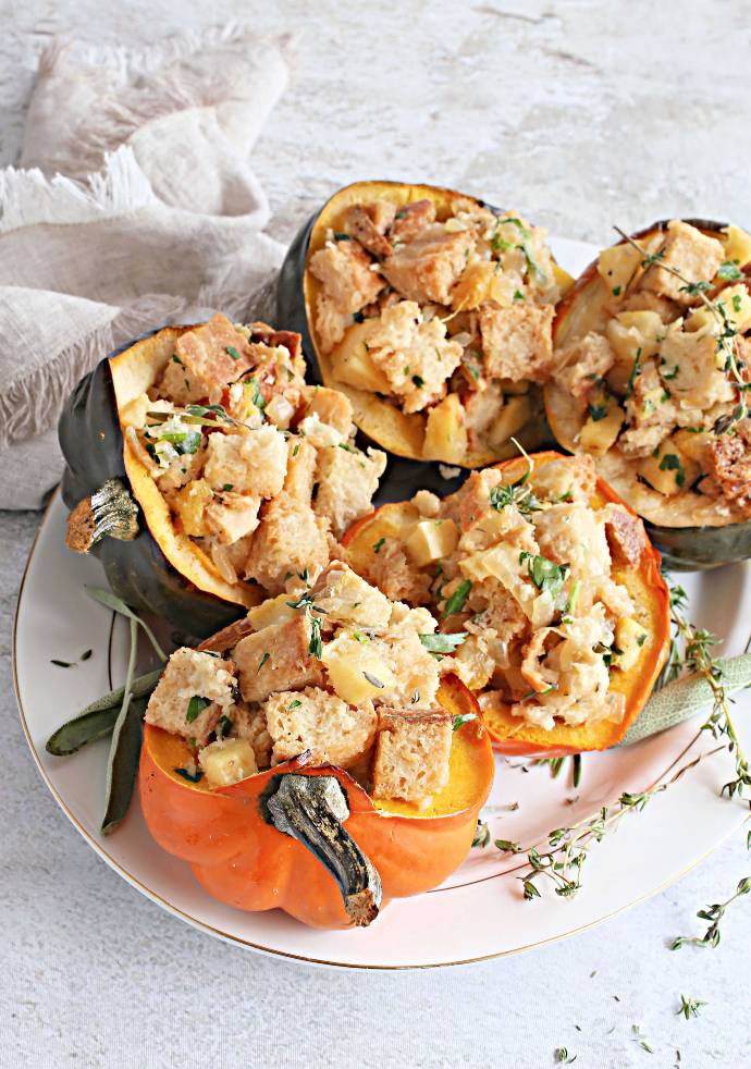 Recipe for buttery fresh herb bread stuffing with roasted acorn squash, served in individual squash bowls.