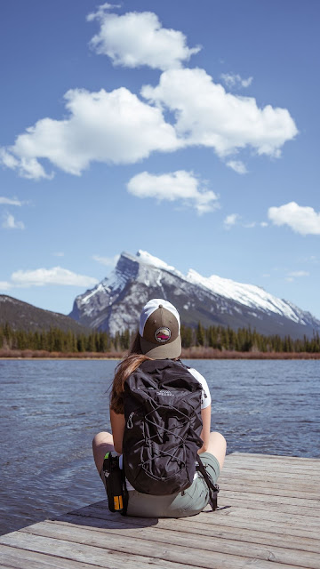 Alone girl with backpack enjoying the mountain landscape Alone girl with backpack enjoying the mountain landscape