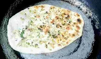 Cooked garlic butter naan on a tawa