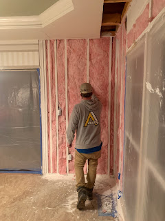 man repairing water damage from flood