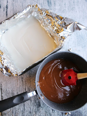 pan of white chocolate next to a saucepan with melted caramel