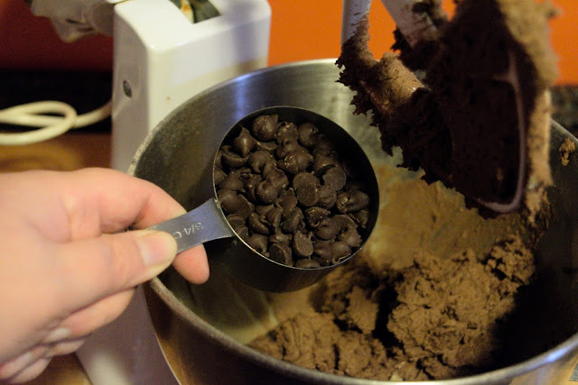 The semi-sweet chocolate chips being added to the dough.