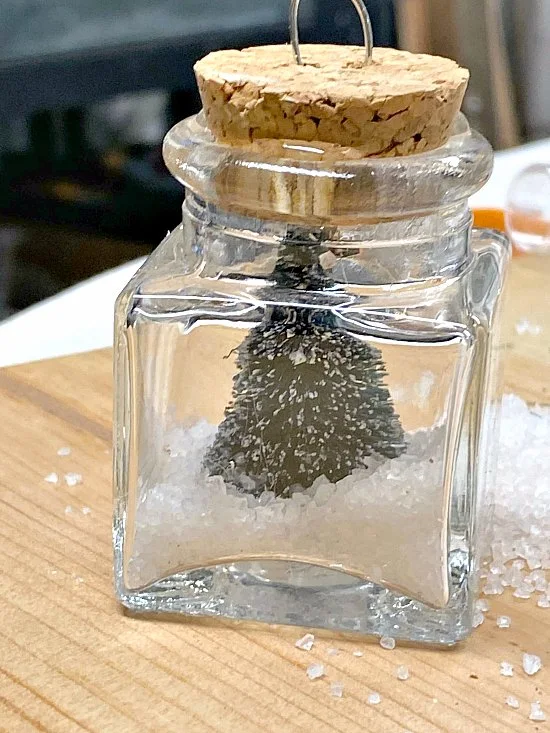 tiny jar with cork lid filled with snow