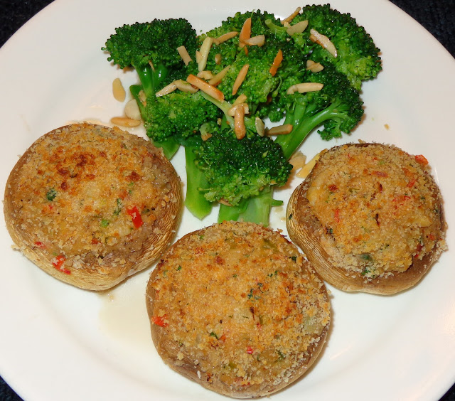 MUSHROOMS STUFFED WITH CRAB CLAWS MEAT PORTIONS: 3 INGREDIENTS 9 large white mushrooms 2 tbsp. lemon juice ½ lb. / 227 g crab claws meat 3 tbsp. soft butter ¾ cup onions, diced 1 garlic clove minced ¼ cup green peppers, diced  1/3 cup red peppers diced 1½ tbsp. chopped parsley 3 tbsp. all-purpose flour ¾ cup milk ¼ tsp. ground black pepper ½ tsp. salt 2 tbsp. Panko bread crumbs Olive oil spray METHOD Remove the mushrooms stems and save for a soup or rice. Wash de mushrooms and dry with paper towel. Brush with lemon juice the mushrooms caps. At moderate flame, melt the butter in a frying pan and sauté the garlic and onion until transparent.  Add and cook peppers for 1 minute. Stir in the flour and cook until is lightly brown. Incorporate the milk and mix well. Let it cook and mix for about 5 minutes making sure it does not burn. Add crab meat, parsley, pepper and salt mixing well. Set the oven in slow broiler and heat it. Stuff the mushrooms caps with the crab meat mix and sprinkle top with bread crumbs. Spray the caps tops with olive oil. Place the mushrooms in baking tray and broil them for about 14 minutes. Top of the mushrooms should be lightly brown and caps soft. BROCCOLI WITH SLIVERED ALMONDS AND GARLIC PORTIONS: 3 INGREDIENTS 12 oz. / 338 g. broccoli florets 1 tbsp. olive oil 1 tbsp. butter 2 garlic cloves chopped 1/3 cup slivered almonds Salt and pepper to taste METHOD Boil some water in a pot with 2 tsp. salt and cook the broccoli florets al dente. Meanwhile at moderate flame heat up a pan with the olive oil and melt butter.  Add garlic, slivered almonds and lightly brown it. Drain the broccoli florets and mix with the browned garlic and almonds, Season it with salt and pepper. Serve the broccoli with the mushrooms caps.