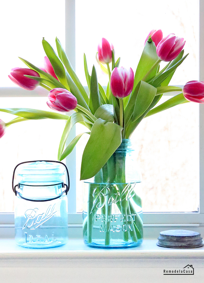 Dark pink tulip bouquets in vintage Blue Mason jars -