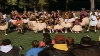 Kids rehearse a large group African dance in the park. sesame street zoe's dance moves