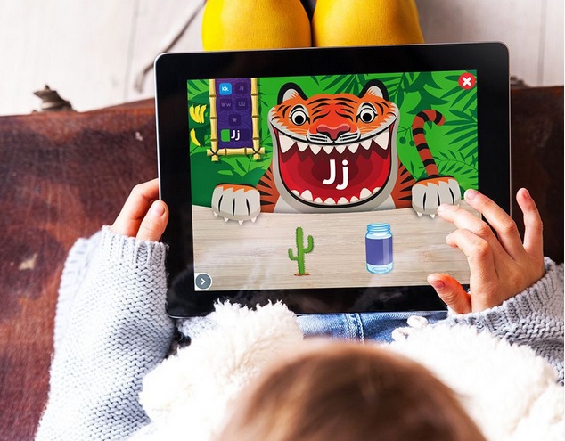 overhead shot of a young girl playing letter name and object matching game on Anywhere Teacher