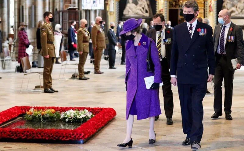 Princess Anne wore an eye-catching purple coat and matching hat, a pale lilac scarf and black knee-high boots