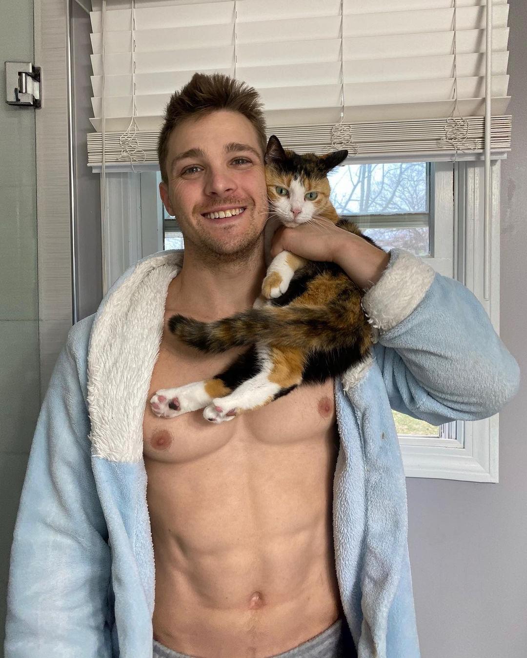 cute-shirtless-fit-guy-cody-messner-hugging-cat-pet-smiling-huge-pecs