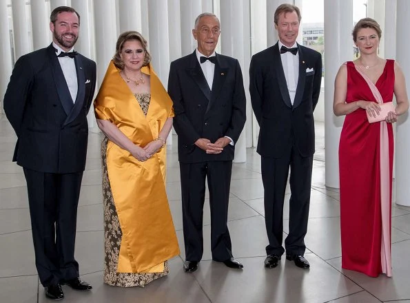 Princess Stephanie wore a red dress by French fashion house Paule Ka. Duchess Maria Teresa wore a dress by Belgian fashion designer Yves Dooms