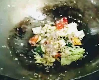 Sauteeing ginger garlic onion bell peppers and Chinese cabbage for ginger honey paneer recipe