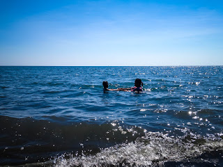 Mother And Daughter Enjoy A Holiday Take A Bath At Sea Water Beach On A Sunny Day