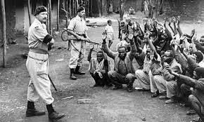 British soldiers with guns raised against black Africans