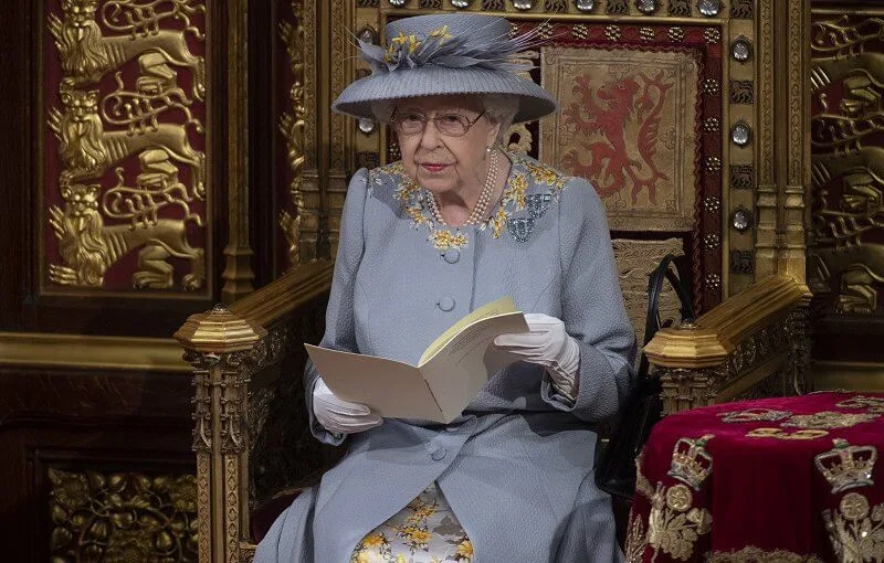 Queen Elizabeth wore a grey jacquard coat with lemon flowers, and a grey and yellow silk dress, and hat by Angela Kelly