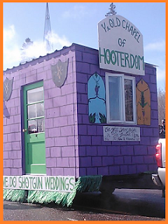 "Ye Old Chapel of Hooterdom" float: purple building with a green door, plumes of smoke rising from it.