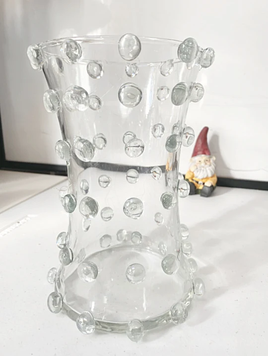 Hot gluing clear gems to a flower vase