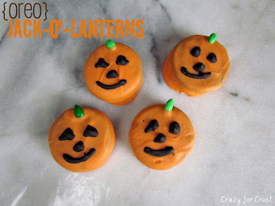 overhead shot of orange jack o lantern decorated oreos with words