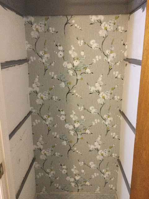 back wall of closet wallpapered