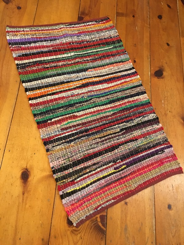 full view of multicolored rag rug