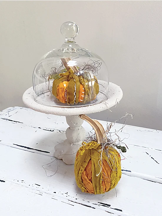 rag pumpkins in a cloche