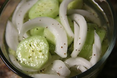 A cucumber and sweet Vidalia onion salad, dressed with a sweet and sour vinegar dressing.