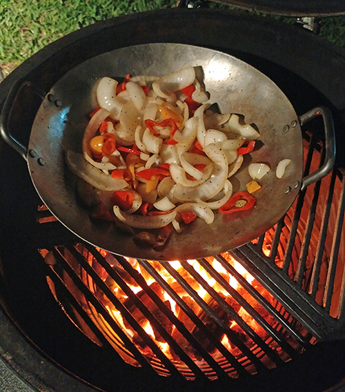 Cooking stir fry on a Big Green Egg equipped with Craycort cast iron grates.