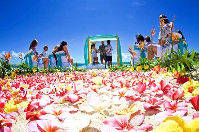 Hawaii beach wedding with the minister listening as he talks at their wedding