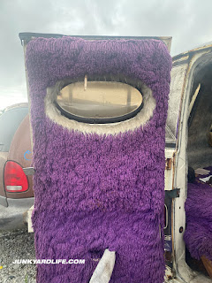 Purple shag carpet everywhere inside Dodge van.