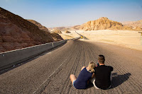 Couple sitting alone on road
