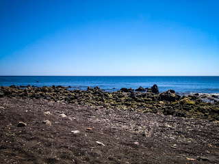 Natural Beach Sand And Rocky Beach View In The Clear Blue Sky On A Sunny Day At Umeanyar Village North Bali Indonesia