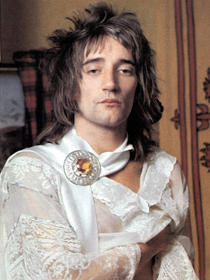 Rod Stewart 1970s publicity picture in white with a white neck scarg